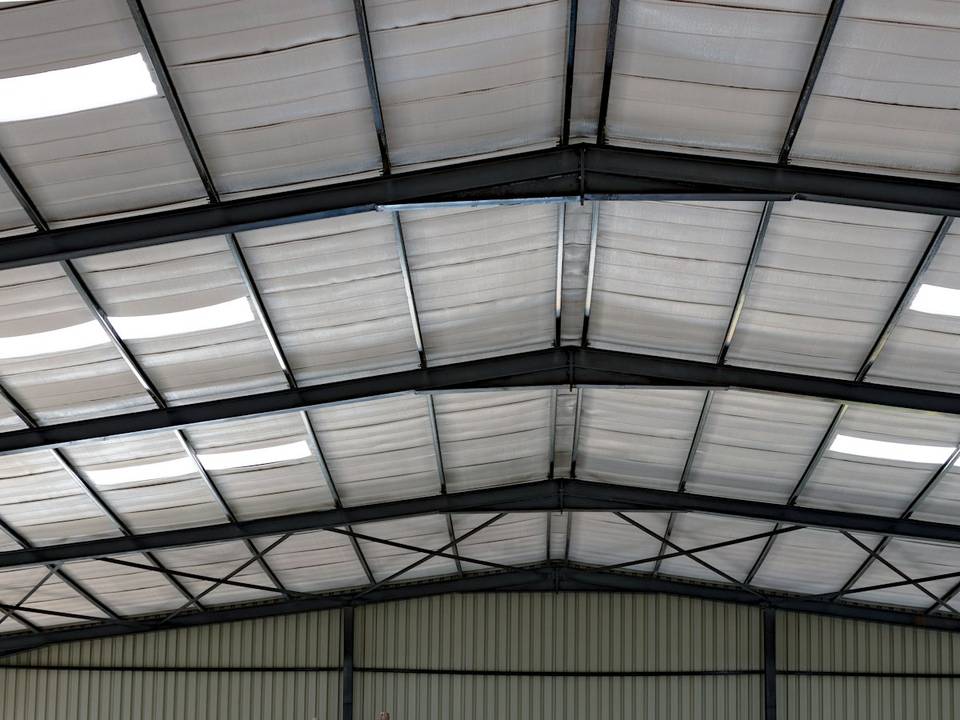 Metal building being insulated near Lindale