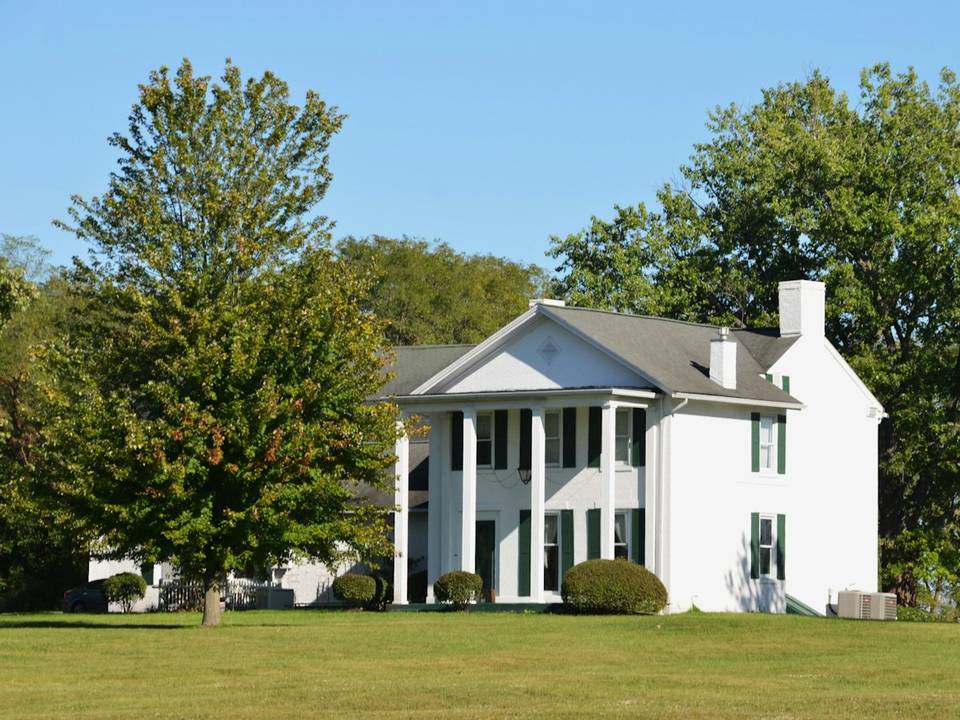 Two story home with mature trees in East Texas